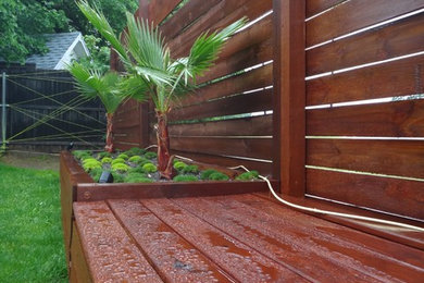 Design ideas for a mid-sized modern full sun backyard landscaping in Dallas with decking.