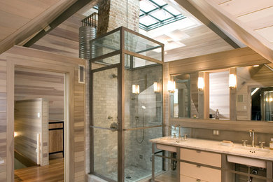 Trendy 3/4 gray tile medium tone wood floor corner shower photo in Austin with flat-panel cabinets, an undermount sink and white cabinets