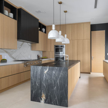 Malibu Contemporary Kitchen with Waterfall Island and Full Marble Backsplash