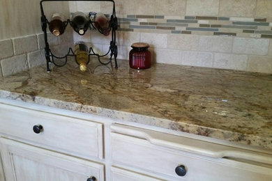 Mid-sized transitional u-shaped eat-in kitchen photo in Seattle with an undermount sink, recessed-panel cabinets, distressed cabinets, granite countertops, beige backsplash, stone tile backsplash, white appliances and a peninsula