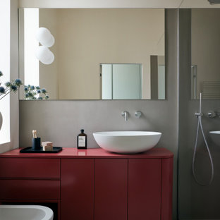 Contemporary 3/4 bathroom in Milan with red cabinets, cement tiles, a vessel sink, red benchtops, a single vanity and a freestanding vanity.