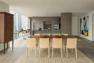 Inspiration for a large contemporary medium tone wood floor and brown floor kitchen/dining room combo remodel in New York with white walls and no fireplace