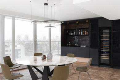 Medium sized urban open plan dining room in London with medium hardwood flooring, brown floors and feature lighting.