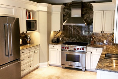 Mid-sized transitional u-shaped travertine floor enclosed kitchen photo in Toronto with a double-bowl sink, recessed-panel cabinets, white cabinets, marble countertops, green backsplash, stone slab backsplash, stainless steel appliances and no island