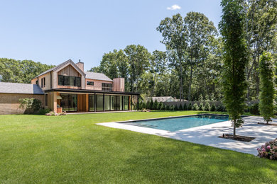 Pool - mid-sized contemporary backyard pool idea in New York