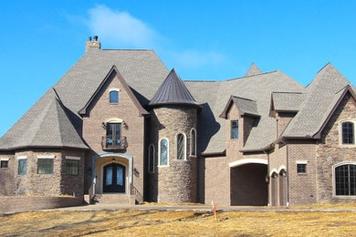 Inspiration for a huge timeless brown three-story brick exterior home remodel in Nashville with a shingle roof