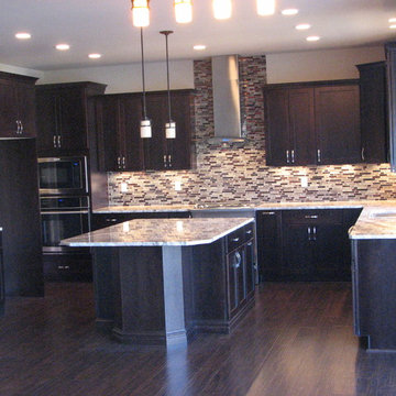 Netuno Bordeaux granite on cherry espresso cabinets