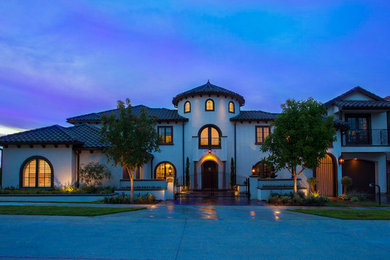 Small tuscan white two-story stucco exterior home photo in Dallas