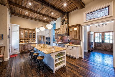 Inspiration for a mid-sized farmhouse single-wall dark wood floor and brown floor eat-in kitchen remodel in Other with a farmhouse sink, shaker cabinets, white cabinets, granite countertops, brown backsplash, wood backsplash, stainless steel appliances and an island