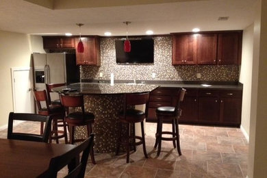 Enclosed kitchen - large single-wall ceramic tile enclosed kitchen idea in Indianapolis with a drop-in sink, dark wood cabinets, granite countertops, multicolored backsplash, mosaic tile backsplash, stainless steel appliances and an island