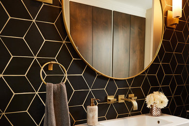 Photo of a mid-sized transitional bathroom in San Francisco with black tile, ceramic tile, black walls and a single vanity.