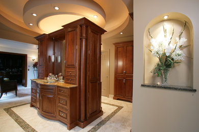 Example of a large classic master beige tile porcelain tile and beige floor double shower design in Kansas City with medium tone wood cabinets, beige walls, raised-panel cabinets, an undermount sink, granite countertops and a hinged shower door
