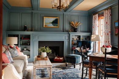 Elegant carpeted, multicolored floor and wainscoting family room library photo in Boston with blue walls, a standard fireplace, a stone fireplace and no tv