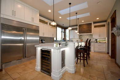 Large country l-shaped eat-in kitchen photo in Chicago with shaker cabinets and an island