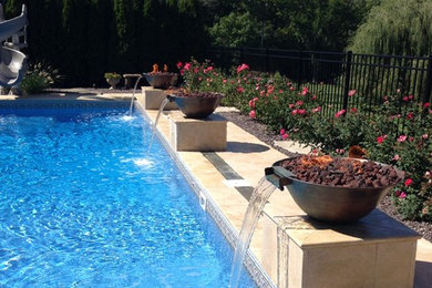 Pool fountain - large traditional backyard tile and rectangular pool fountain idea in Chicago