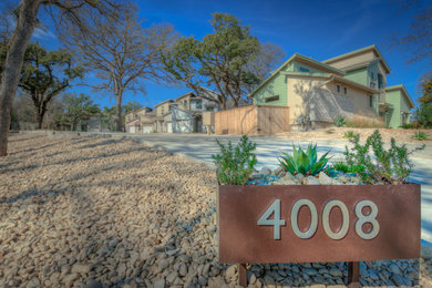This is an example of a mid-sized contemporary partial sun gravel landscaping in Austin.
