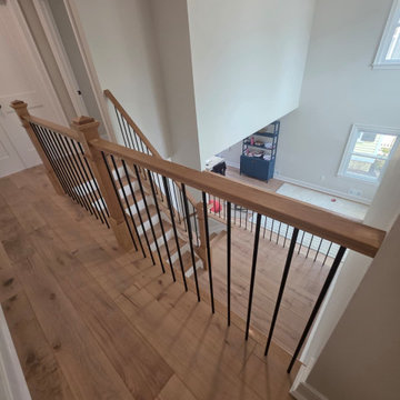 Metal and Wood Indoor Railing Installation with Red Oak T-Rail & Black Balusters