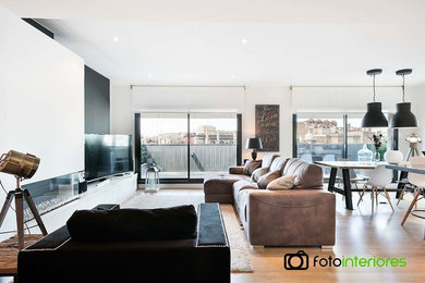 This is an example of a mid-sized modern open concept living room in Barcelona.