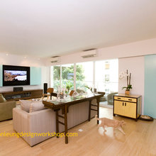 tv console suspended with tv mounted and frosted glass sliding door