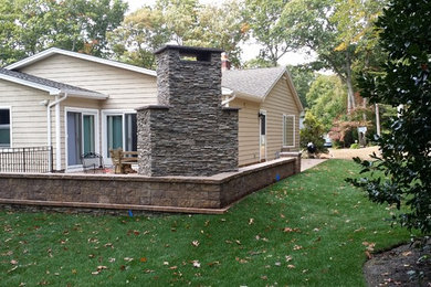 Patio - large traditional courtyard brick patio idea in New York with a fire pit and a pergola