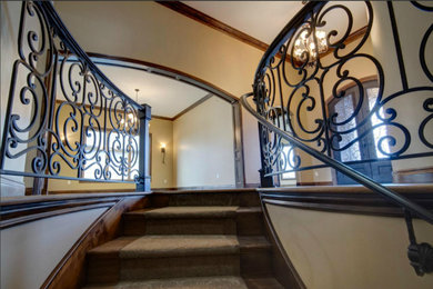 Inspiration for a mid-sized timeless wooden curved staircase remodel in Wichita with wooden risers