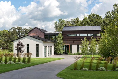 Trendy brown two-story mixed siding exterior home photo in Minneapolis with a metal roof