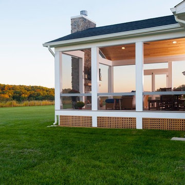 Design Builders screened porch with stone fireplace & Ipe deck in Sykesville MD