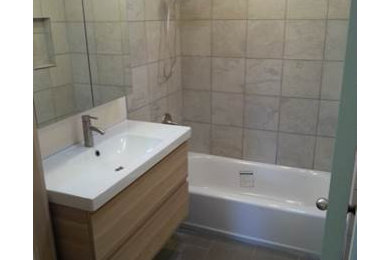 Example of a small transitional 3/4 ceramic tile and beige tile ceramic tile bathroom design in Seattle with flat-panel cabinets, light wood cabinets, a one-piece toilet, beige walls and an integrated sink