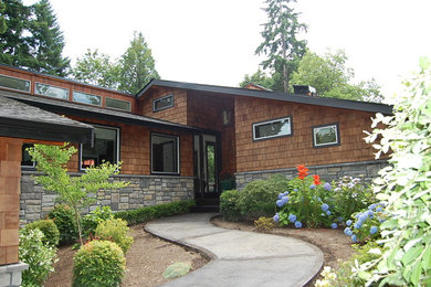 Inspiration for a large modern brown one-story mixed siding exterior home remodel in Seattle with a shed roof