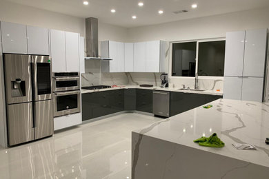 Mid-sized minimalist porcelain tile and gray floor kitchen photo in Los Angeles with flat-panel cabinets, yellow cabinets, quartzite countertops, white backsplash, an island and white countertops