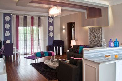 Inspiration for a large eclectic open concept medium tone wood floor living room remodel in Other with a bar, a tv stand and gray walls
