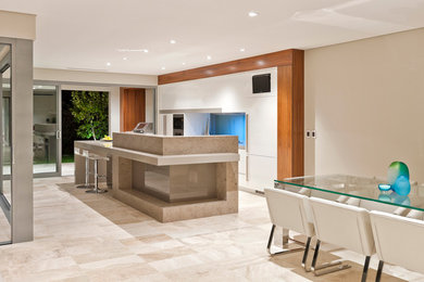 This is an example of a mid-sized contemporary galley eat-in kitchen in Perth with louvered cabinets, white cabinets, quartz benchtops, blue splashback, glass sheet splashback, stainless steel appliances, travertine floors and with island.