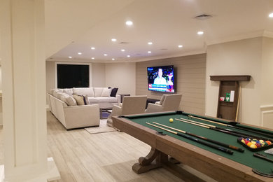 Large transitional enclosed vinyl floor, beige floor and shiplap wall family room photo in New York with beige walls and a wall-mounted tv