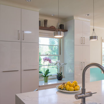 Marble Countertops and White Cabinets with Stylish Pendant Lighting