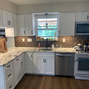 kitchen remodel--white cabinets with granite and brown glass splash