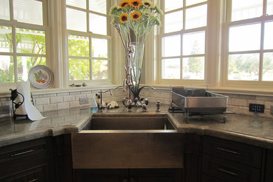 Example of a huge classic l-shaped eat-in kitchen design in San Luis Obispo with a farmhouse sink, recessed-panel cabinets, medium tone wood cabinets, quartzite countertops, beige backsplash, stone tile backsplash, two islands and stainless steel appliances