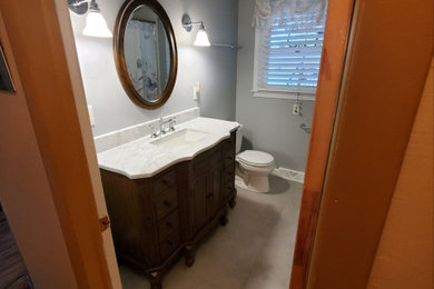Mid-sized elegant laminate floor, beige floor and single-sink bathroom photo in Other with blue walls, quartz countertops, white countertops and a freestanding vanity