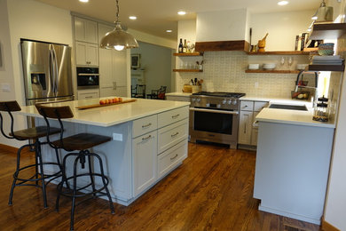 Example of a large minimalist u-shaped open concept kitchen design in Seattle with a farmhouse sink, gray cabinets, ceramic backsplash, stainless steel appliances and an island