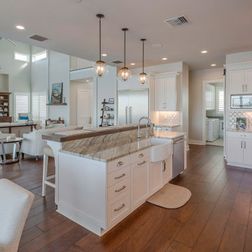 Refined White Kitchen With Quartzite Island And Warm Wood Floors