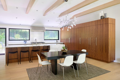 Minimalist l-shaped light wood floor, beige floor and exposed beam eat-in kitchen photo in Philadelphia with an undermount sink, flat-panel cabinets, dark wood cabinets, quartz countertops, white backsplash, quartz backsplash, paneled appliances, an island and white countertops
