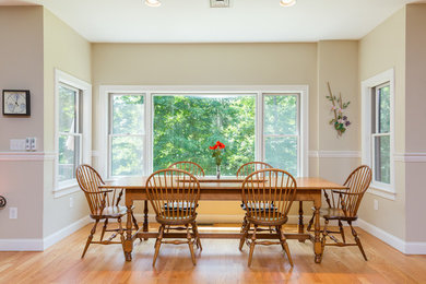 Mid-sized elegant light wood floor and brown floor kitchen/dining room combo photo in Boston with beige walls