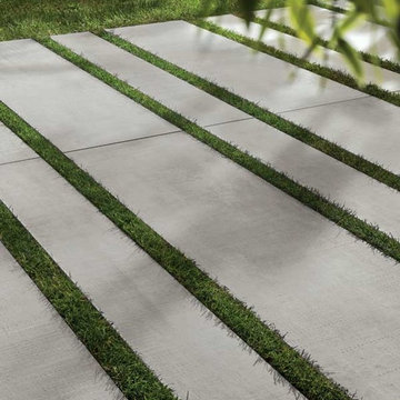 'Cemento' porcelain pavers used as stepping stones in a grassed area