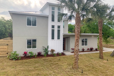 Inspiration for a large modern gray two-story house exterior remodel in Jacksonville with a metal roof