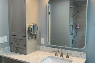 Minimalist multicolored tile and ceramic tile ceramic tile, gray floor and single-sink bathroom photo in Milwaukee with shaker cabinets, gray cabinets, a one-piece toilet, gray walls, an undermount sink, quartz countertops, multicolored countertops, a niche and a built-in vanity