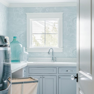 This is an example of a rural separated utility room in Boston with a submerged sink, engineered stone countertops, ceramic flooring, a side by side washer and dryer and blue walls.