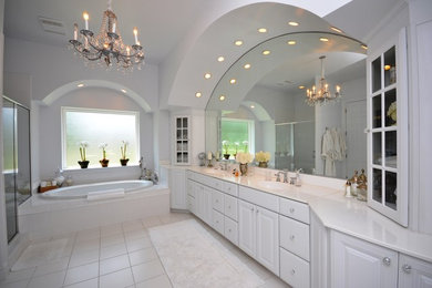 Example of a huge tuscan master white tile and ceramic tile ceramic tile bathroom design in Other with an undermount sink, raised-panel cabinets, white cabinets, granite countertops and gray walls