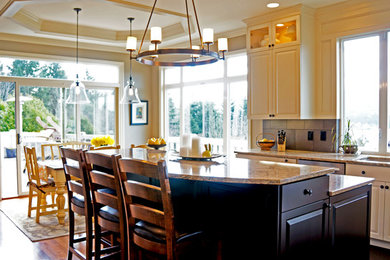 Mid-sized elegant u-shaped medium tone wood floor eat-in kitchen photo in Seattle with an undermount sink, raised-panel cabinets, white cabinets, quartzite countertops, beige backsplash, porcelain backsplash, stainless steel appliances and an island
