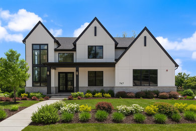 Example of a huge transitional white two-story stone and board and batten exterior home design in Chicago with a shingle roof and a black roof