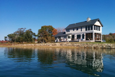 Mid-sized contemporary two-story wood exterior home idea in Portland Maine with a metal roof