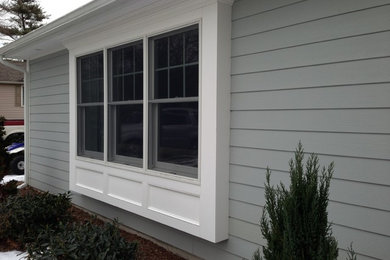 Inspiration for a mid-sized timeless gray one-story mixed siding exterior home remodel in New York